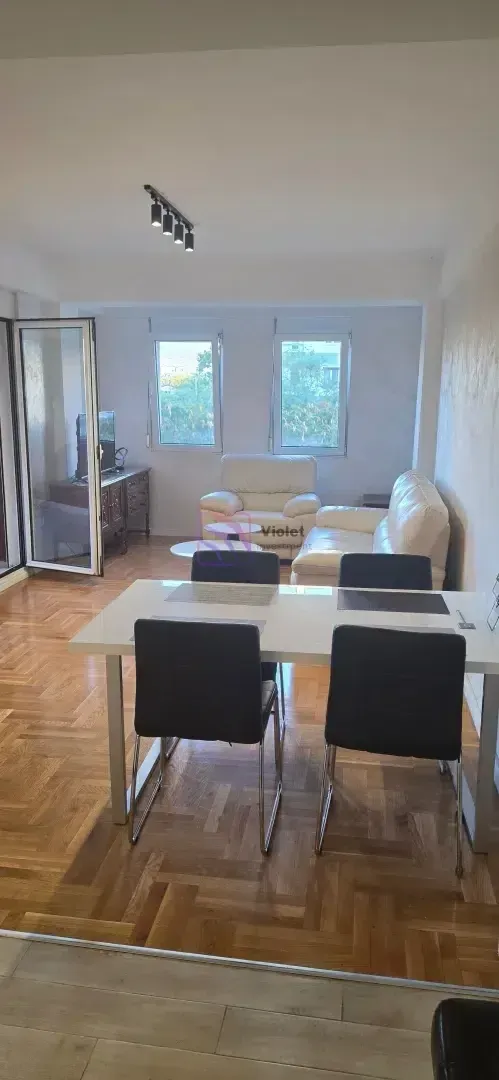 Dnevna soba sa trpezarijom, parketom na podu i izlazom na terasu.