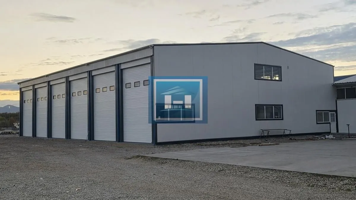 View of the exterior of an industrial warehouse with roller doors.