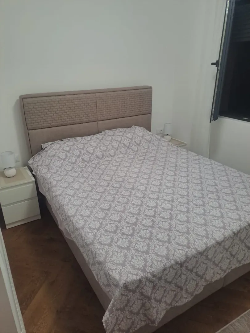 Furnished bedroom with a double bed and bedside tables.