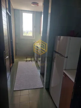 View of a small kitchen with a refrigerator and cabinets. - image 4