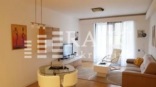 Spacious living room with a dining area and balcony access.
