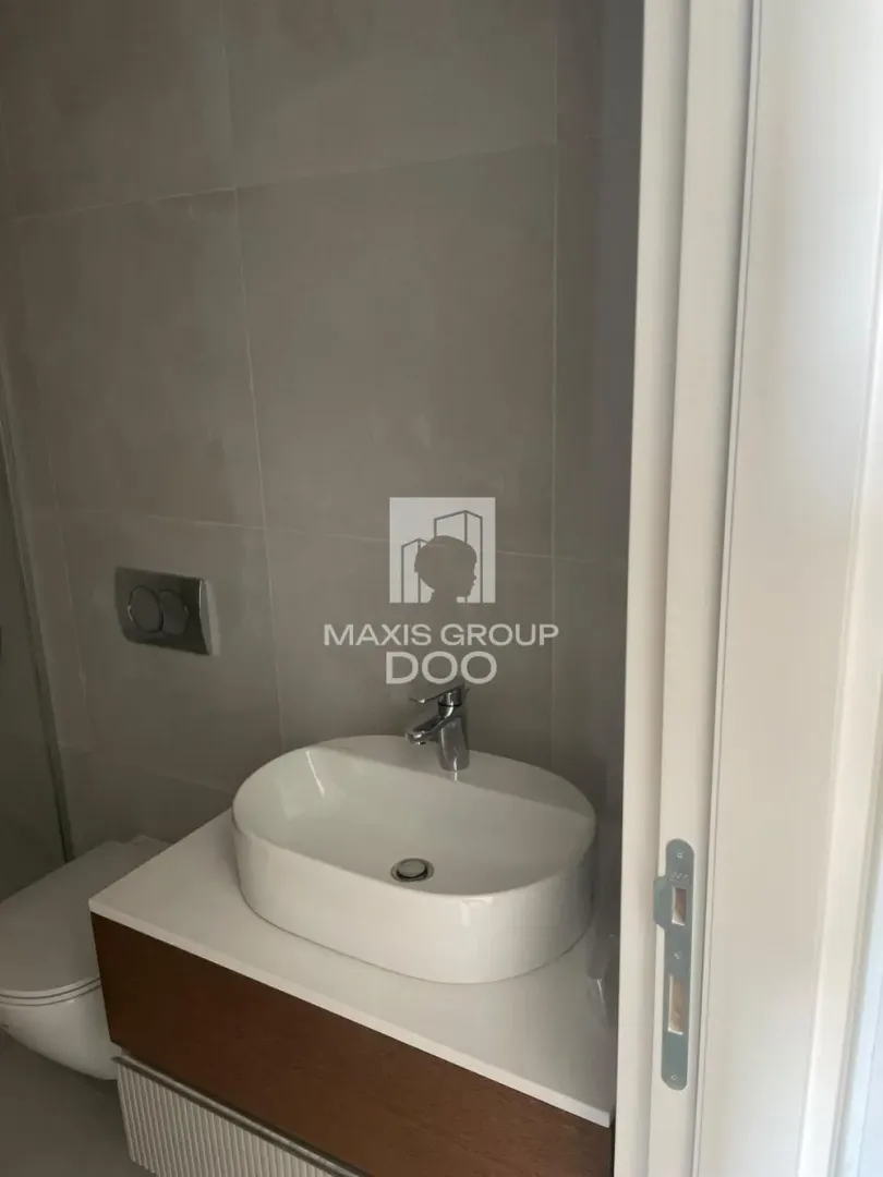 View of the washbasin and toilet in a modern bathroom.