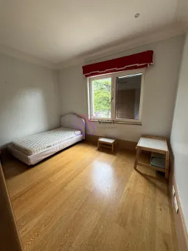 Small bedroom with a bed and wooden floor. - image 20