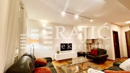 Spacious living room with seating set and TV cabinet.