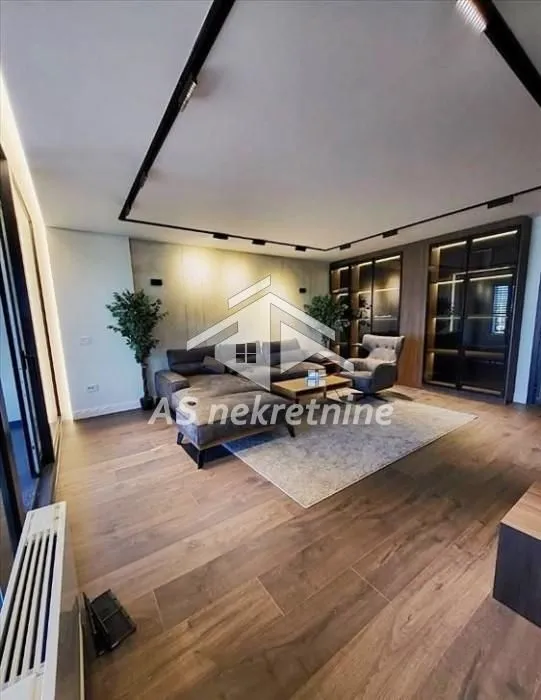 Modern living room with a sofa set and wooden flooring.