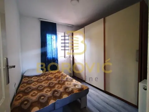 Bedroom with a bed and a large built-in wardrobe. - image 5