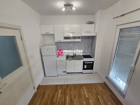 Small white kitchen with a refrigerator, stove, and sink. - image 3