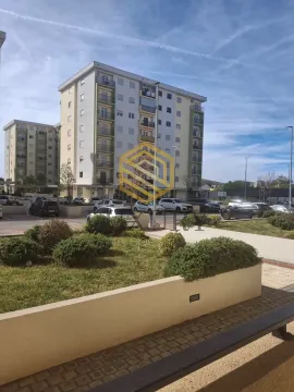 View of the residential building with a landscaped yard and parking. - image 10