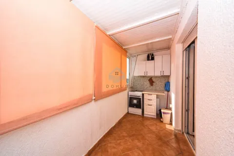 Small kitchen located on a glazed and covered terrace with a stove and kitchen cabinets. - image 9