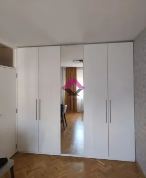 White wardrobe with a mirror in the bedroom. - image 19