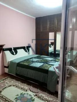 Bedroom with a double bed and wooden wardrobe. - image 5