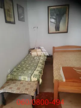Bedroom with two wooden beds and wall paintings. - image 2