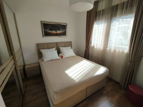Tidy bedroom with a double bed, wardrobe, and window. - image 6