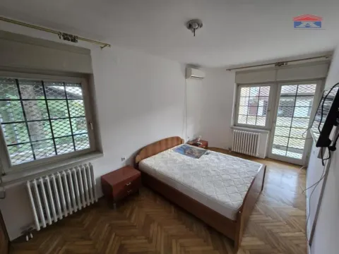 Bedroom with a double bed, wooden flooring and two windows. - image 11