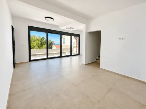 Empty living room with large glass openings and a view of the terrace. - image 9