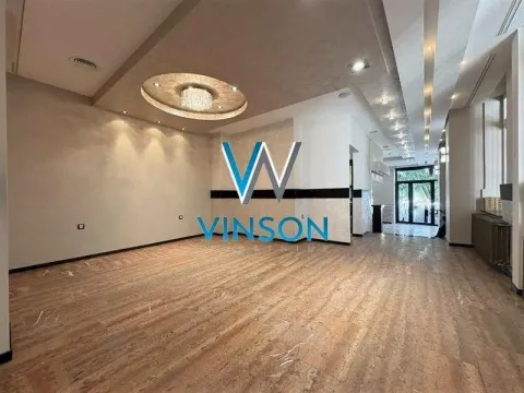 Spacious empty room with a drop ceiling and lighting. - image 7