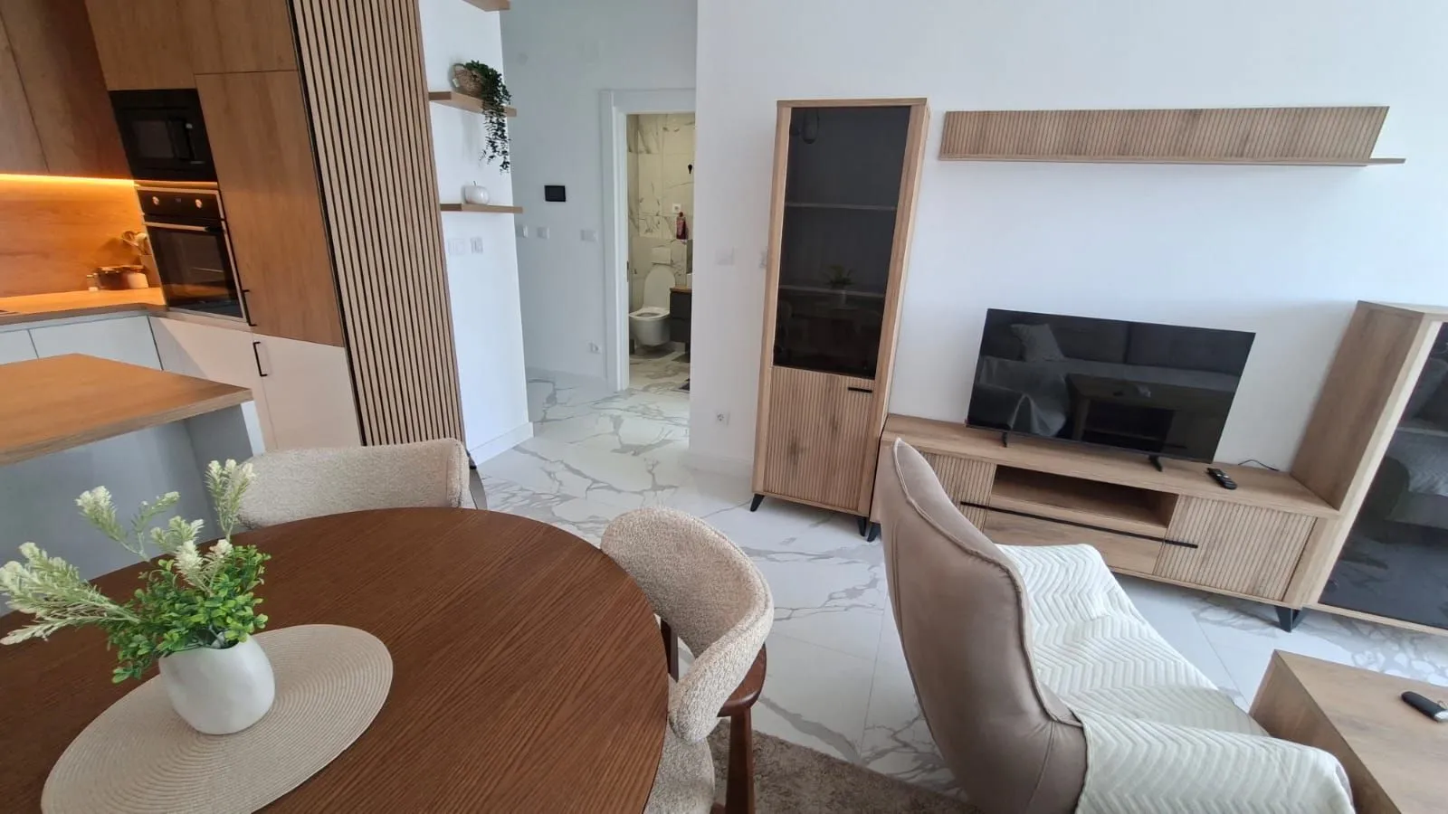 Modern living room connected to the dining area and kitchen.
