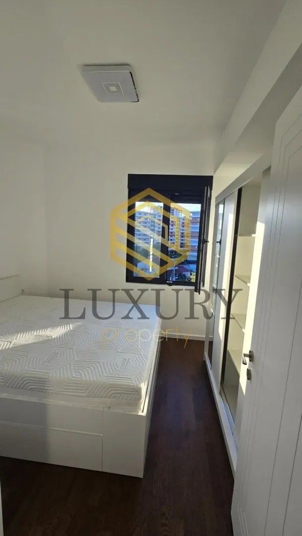 Bright bedroom with a double bed and a fitted wardrobe.
