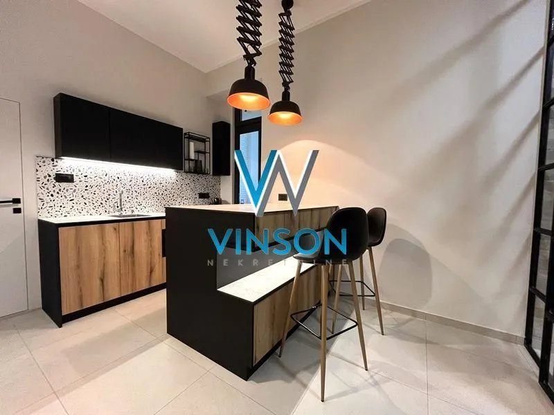 Modern kitchen with a breakfast bar and bar stools.