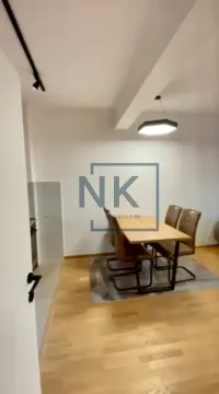 Dining area with a wooden table and chairs on hardwood flooring. - image 6