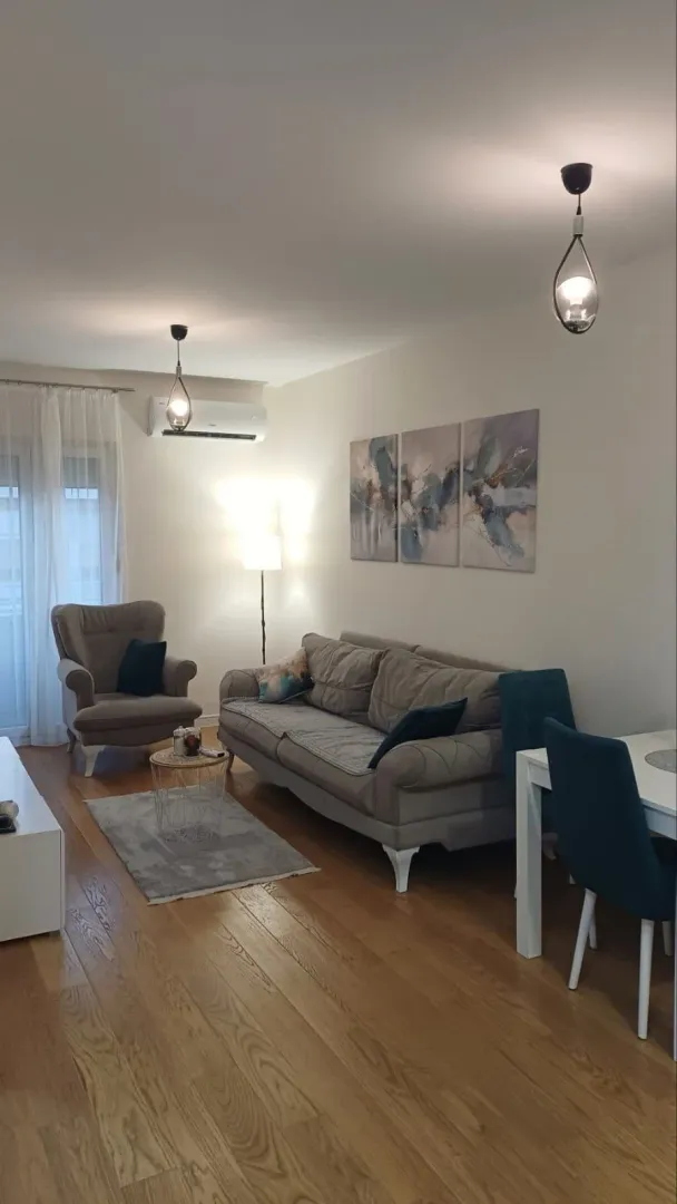 Modern and tidy living room with a sofa set and dining table.