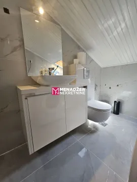 Savremeno opremljeno kupatilo sa umivaonikom i ugradnom sanitarijom. - image 7