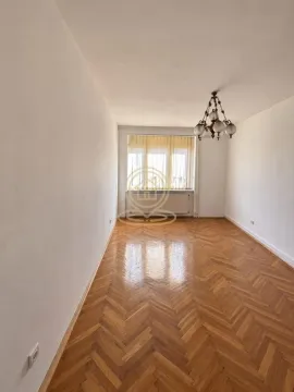 Empty room with parquet flooring and a window. - image 3