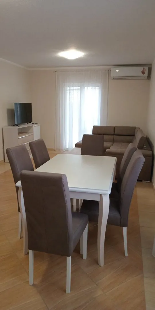 Living room with a dining table and sofa.