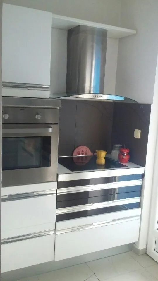 Kitchen elements with a built-in oven and stovetop.