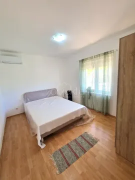 Furnished bedroom with a double bed, wardrobe, and wooden flooring. - image 10