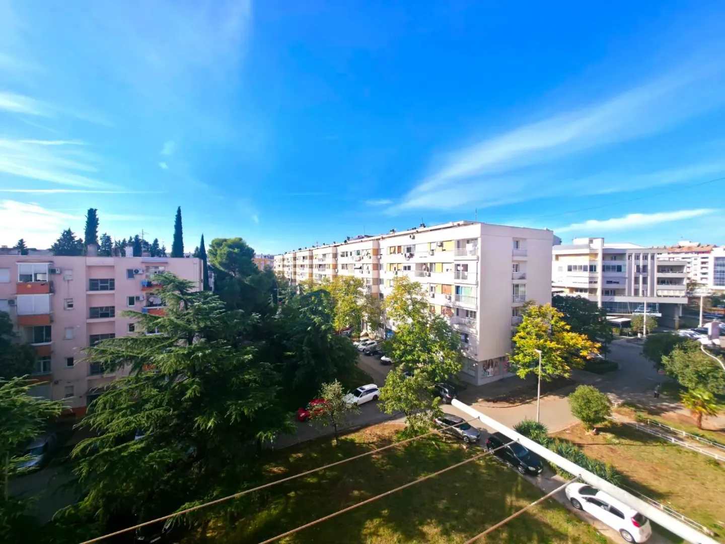 View from the terrace overlooking the urban neighborhood and green areas.