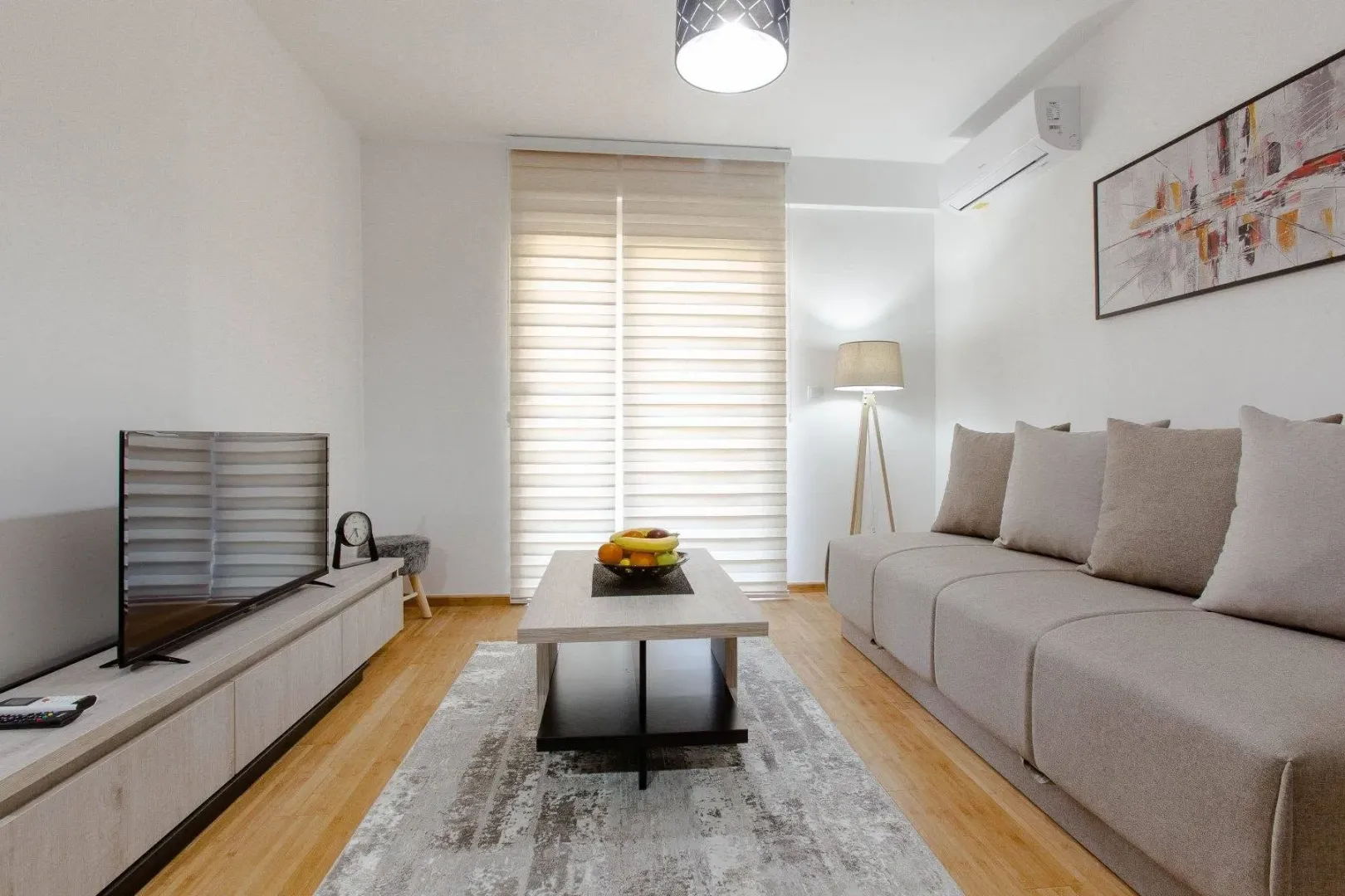 Living room with sofa, television, and coffee table.