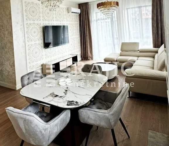 Living room with dining area and sofa set.