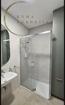 Modern bathroom with a shower cabin, sink, and mirror. - image 8
