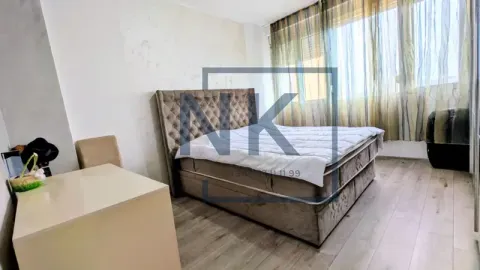 Furnished bedroom with a double bed and curtained window. - image 12