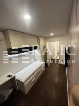 Modern bedroom with a bed and built-in units. - image 15