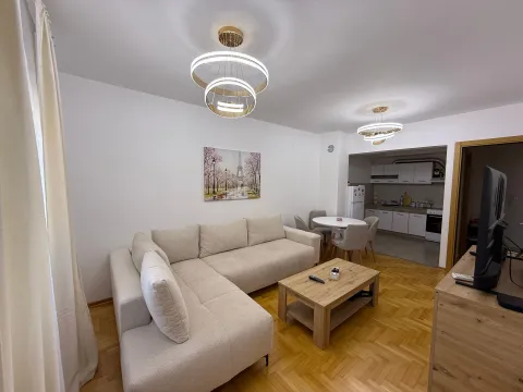 Living room with sofa, dining area, and view of the kitchen. - image 2