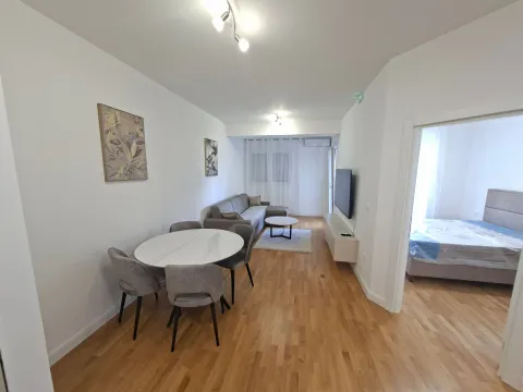 Living room with dining area and a view into the bedroom. - image 4