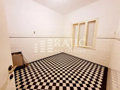 Empty kitchen with black and white floor tiles and white wall tiles. - image 8