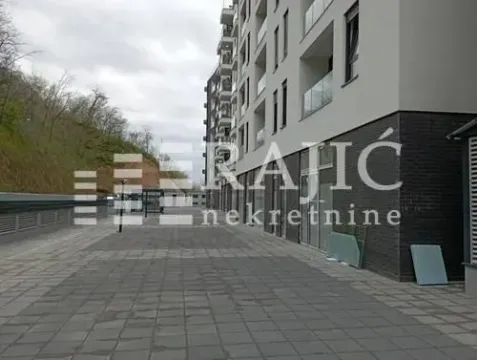 Exterior of a modern residential building with a paved courtyard. - image 12