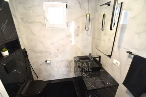 Modernly equipped bathroom with black sanitary ware and marble tiles. - image 14