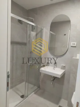 Modern bathroom with a shower cabin, sink and mirror. - image 4