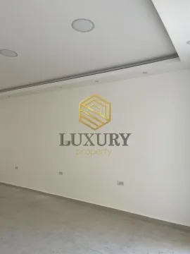 View of a white wall in an empty room with an agency logo placed on it. - image 7