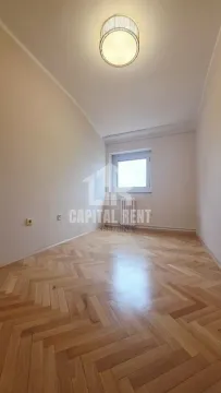 Empty room with parquet flooring and ceiling lighting. - image 5