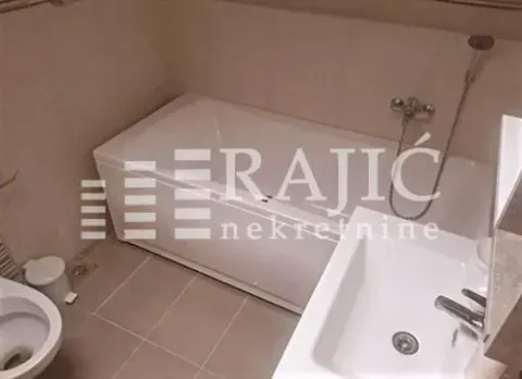 A clear bathroom featuring a bathtub, sink, and toilet. - image 10