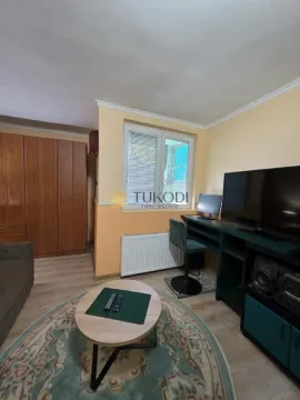 Living room with a seating set, TV, and wooden wardrobe. - image 3