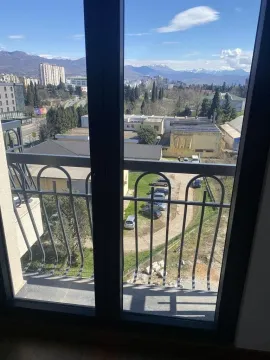 View from the balcony overlooking the city and surrounding mountains. - image 10