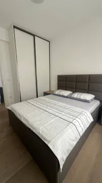 Furnished bedroom with a double bed and a fitted wardrobe. - image 7