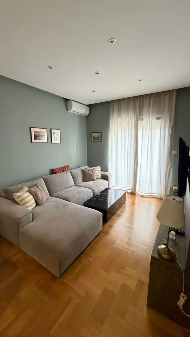 Living room with a sectional sofa, coffee table and TV.