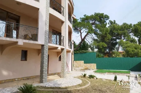 View of the exterior of the building with balconies and a landscaped yard. - image 19